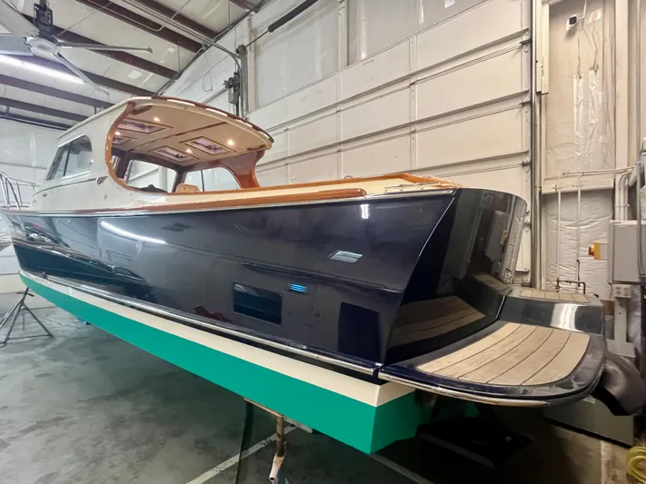  Yacht Photos Pics 2005 Hinckley Picnic Boat EP in a garage, showcasing sleek design and craftsmanship.