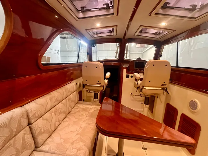  Yacht Photos Pics Interior of 2005 Hinckley Picnic Boat EP with elegant seating and wooden finishes.