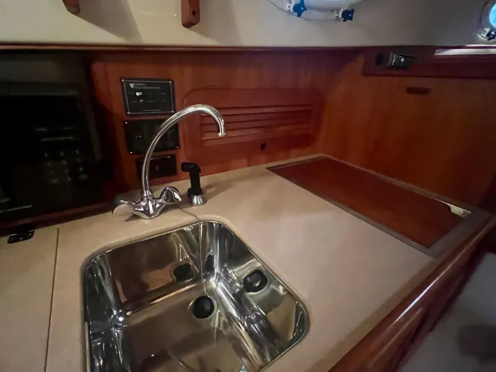  Yacht Photos Pics 2005 Hinckley Picnic Boat EP interior with sink and wooden cabinetry.
