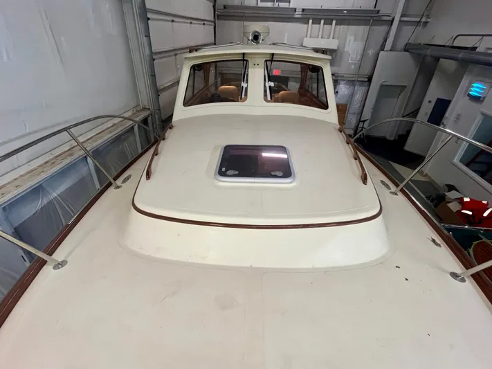  Yacht Photos Pics 2005 Hinckley Picnic Boat EP in storage, showcasing deck and cabin exterior.