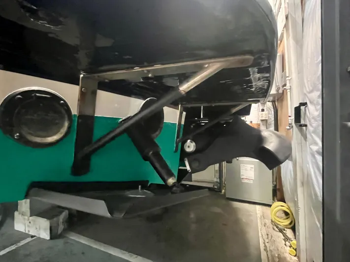  Yacht Photos Pics 2005 Hinckley Picnic Boat EP stern view in storage, showcasing propeller and rudder.