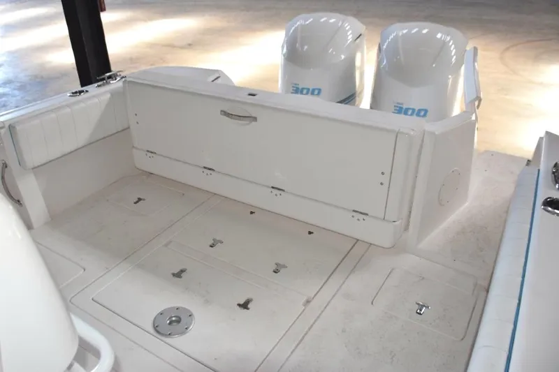 Oz Yacht Photos Pics Cockpit with rear seat hatch closed and transom door open. Livewell and fish boxes below deck hatches.