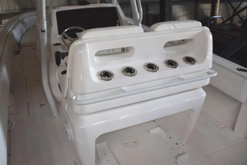 Oz Yacht Photos Pics Behind helm seat console, drink holder or rod holders and safety grab railing, cooler chocks beneath.