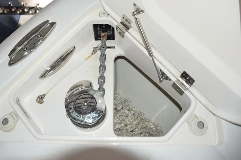 Oz Yacht Photos Pics Electric anchor windlass with safety lanyard and thru-hull chute - stainless claw anchor, chain lead and nylon rode. Switches here and at helm.