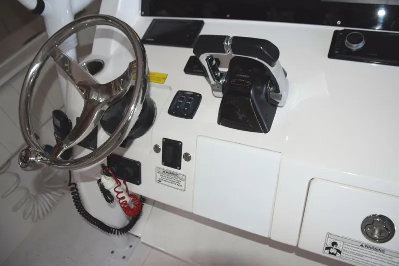 Oz Yacht Photos Pics Tiltable helm wheel Yamaha control binnacle and digital engine display, bow thruster and trim tab controls.