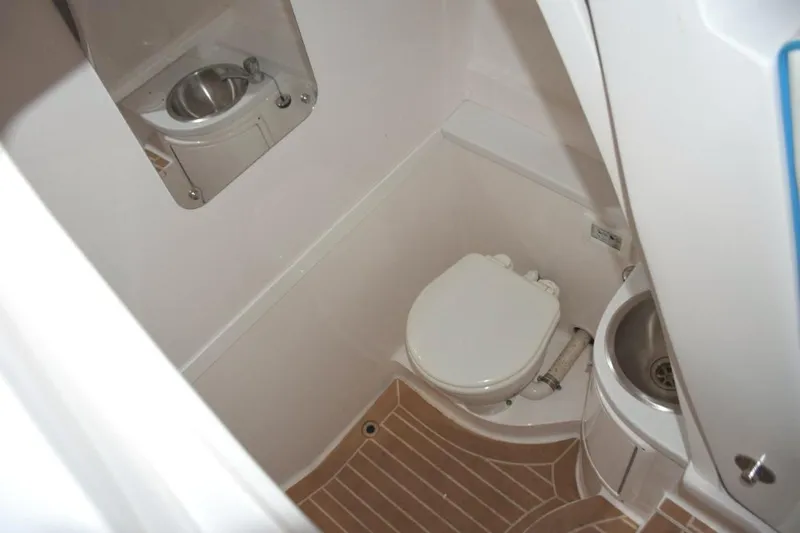 Oz Yacht Photos Pics Freshwater head, stainless steel sink with faucet which doubles as shower wand, drained sole with SeaDek, mirror.