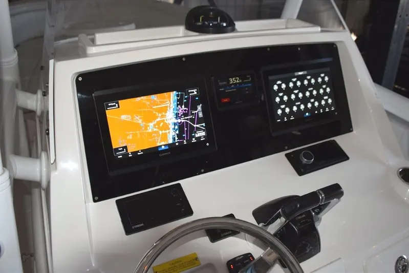 Oz Yacht Photos Pics Magnetic compass on top of helm, Fusion stereo to starboard.