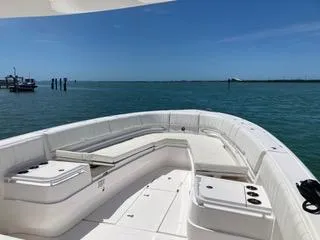  Yacht Photos Pics 2019 Intrepid 400 Center Console boat with spacious seating, docked on calm blue waters.