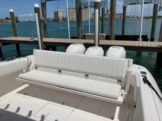  Yacht Photos Pics 2019 Intrepid 400 Center Console boat with white seating, docked by the water.