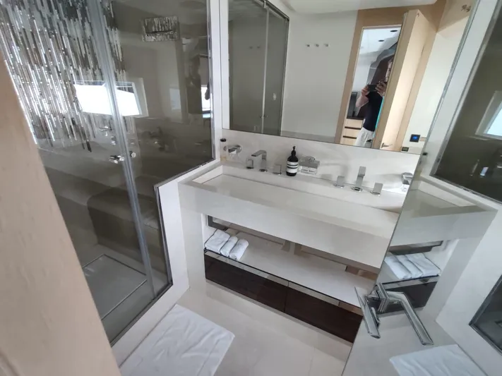  Yacht Photos Pics Luxurious bathroom in 2017 Dominator Ilumen 28 yacht with modern fixtures and glass shower.
