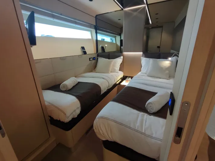  Yacht Photos Pics Luxurious twin cabin in 2017 Dominator Ilumen 28 yacht, featuring modern design and cozy bedding.