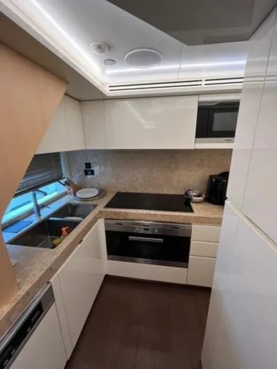  Yacht Photos Pics Modern kitchen interior on 2017 Dominator Ilumen 28 yacht, featuring sleek cabinetry and appliances.