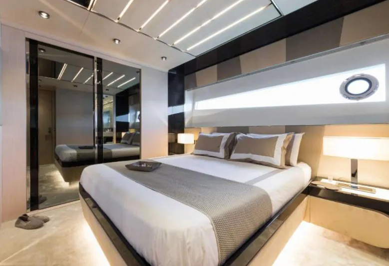  Yacht Photos Pics Luxurious bedroom interior on 2017 Dominator Ilumen 28 yacht, featuring modern design and elegant lighting.