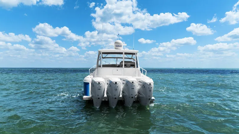 Damn Lucky Yacht Photos Pics 2019 Intrepid 475 boat with four engines on open sea under blue sky.
