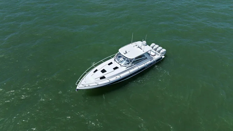 Damn Lucky Yacht Photos Pics 2019 Intrepid 475 boat cruising on open water, aerial view.