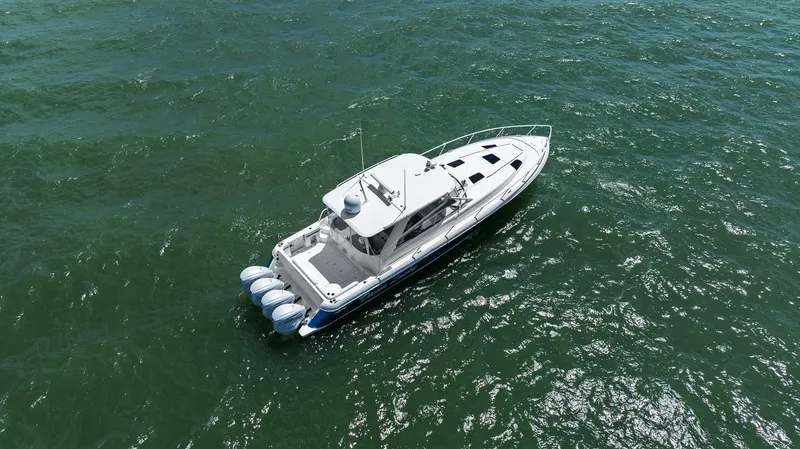 Damn Lucky Yacht Photos Pics Aerial view of 2019 Intrepid 475 boat cruising on open water.