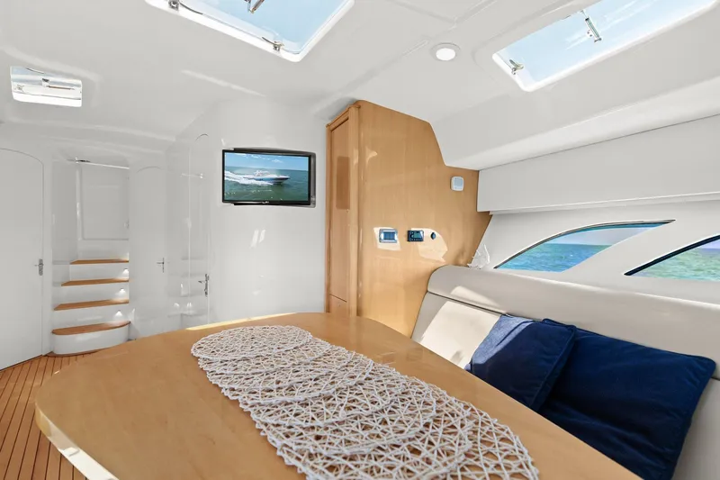 Damn Lucky Yacht Photos Pics Luxurious interior of 2019 Intrepid 475 yacht with modern design and ocean view.