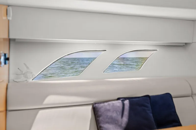 Damn Lucky Yacht Photos Pics Interior view of 2019 Intrepid 475 yacht with ocean visible through sleek windows.