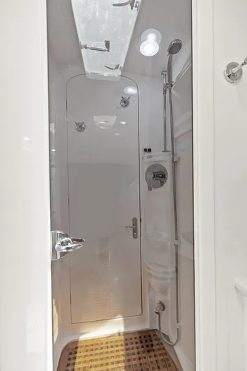 Damn Lucky Yacht Photos Pics Shower area in 2019 Intrepid 475 boat, featuring sleek design and modern fixtures.
