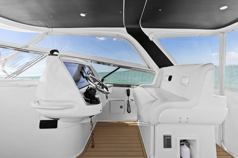 Damn Lucky Yacht Photos Pics Interior of 2019 Intrepid 475 boat with modern helm and ocean view.