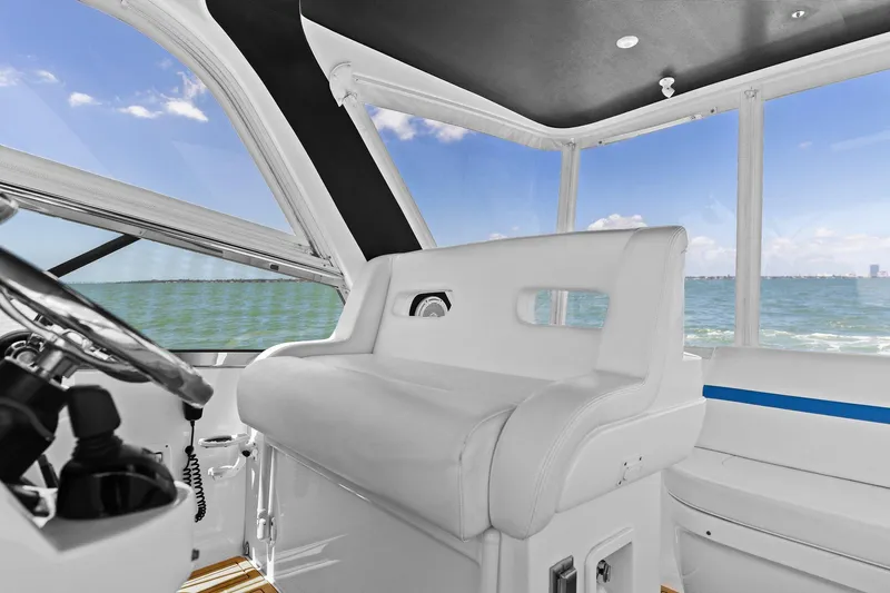Damn Lucky Yacht Photos Pics Luxurious interior of 2019 Intrepid 475 boat with plush seating and panoramic windows.