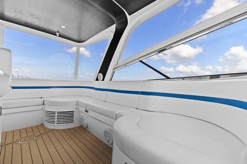 Damn Lucky Yacht Photos Pics Luxurious interior of 2019 Intrepid 475 boat with sleek seating and panoramic windows.
