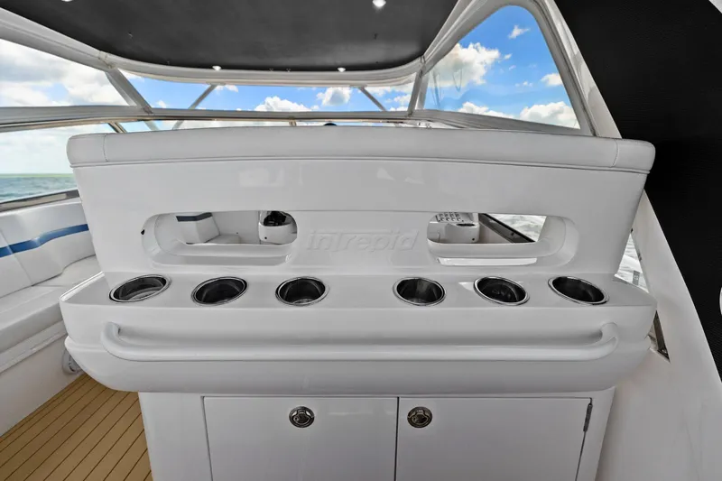 Damn Lucky Yacht Photos Pics 2019 Intrepid 475 yacht interior with cup holders and storage cabinets.