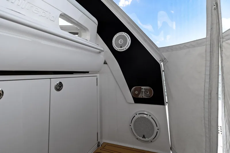 Damn Lucky Yacht Photos Pics Interior view of a 2019 Intrepid 475 boat, featuring sleek cabinetry and built-in speakers.