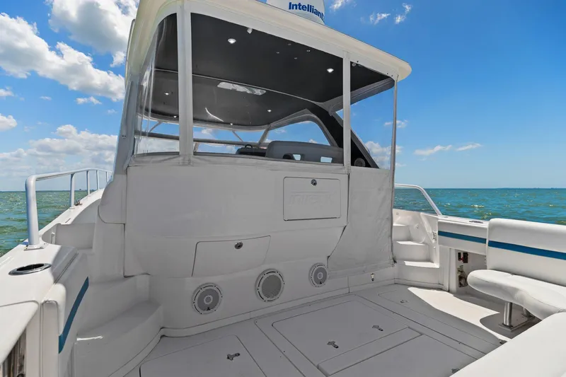Damn Lucky Yacht Photos Pics 2019 Intrepid 475 boat deck with seating, ocean view, and clear blue sky.