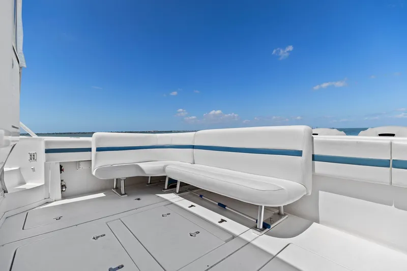 Damn Lucky Yacht Photos Pics 2019 Intrepid 475 yacht deck with white seating and ocean view.