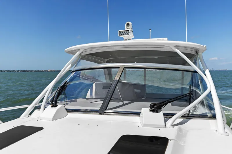 Damn Lucky Yacht Photos Pics 2019 Intrepid 475 boat on water, featuring sleek design and advanced navigation equipment.