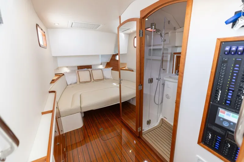 New Mjm 4 Yacht Photos Pics Luxurious 2025 MJM 4 yacht interior with cozy bed, wooden flooring, and modern bathroom.