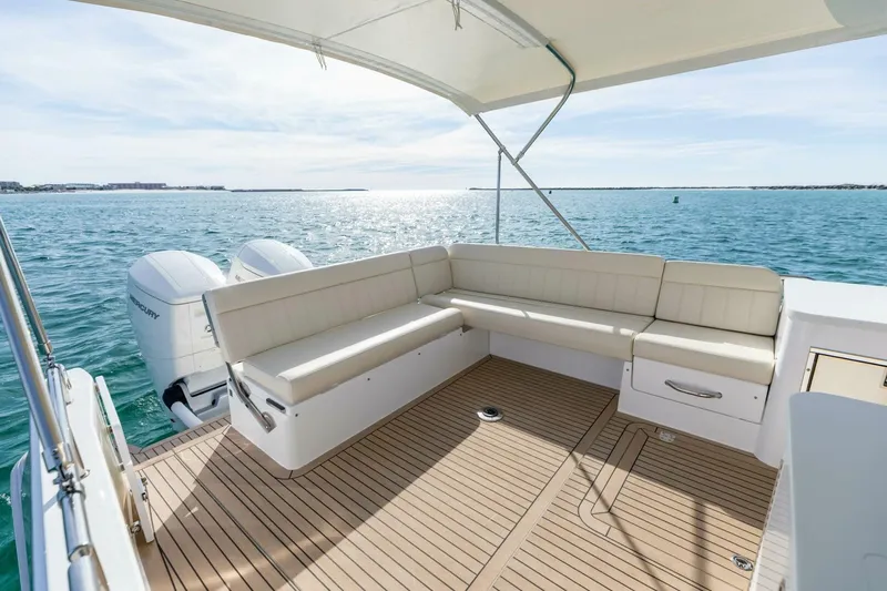 New Mjm 4 Yacht Photos Pics Luxury MJM 4 boat deck with seating, overlooking serene ocean waters, 2025 model.