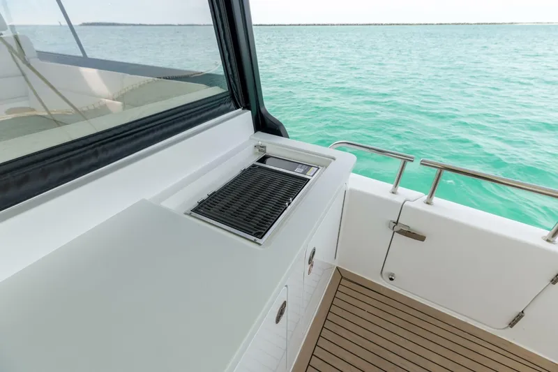 New Mjm 4 Yacht Photos Pics Luxury MJM 4 yacht deck with grill, overlooking turquoise ocean waters, 2025 model.