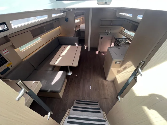 Lena S. Yacht Photos Pics Modern interior of 2023 Beneteau Oceanis 40.1 yacht with dining area and kitchen.
