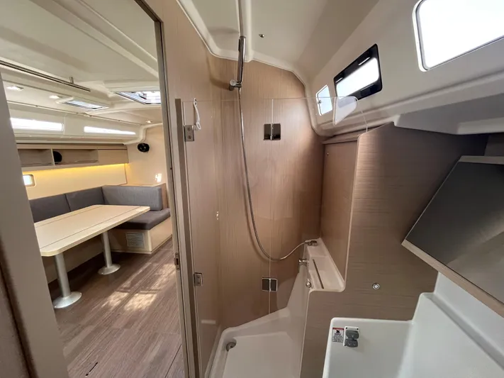 Lena S. Yacht Photos Pics Interior of 2023 Beneteau Oceanis 40.1 yacht, featuring modern shower and dining area.