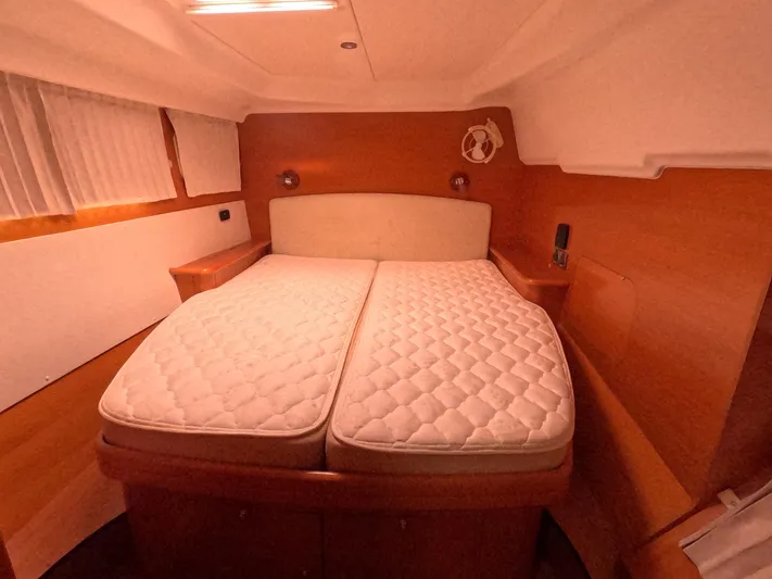 Orion Yacht Photos Pics 2006 Lagoon 440 cabin interior with double bed and wooden finish.