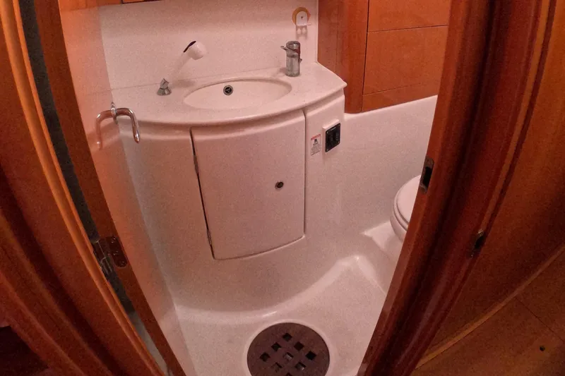 Orion Yacht Photos Pics Compact bathroom in a 2006 Lagoon 440 yacht, featuring a sink and toilet.