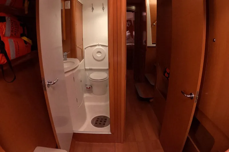 Orion Yacht Photos Pics 2006 Lagoon 440 yacht bathroom with wooden interior and compact design.