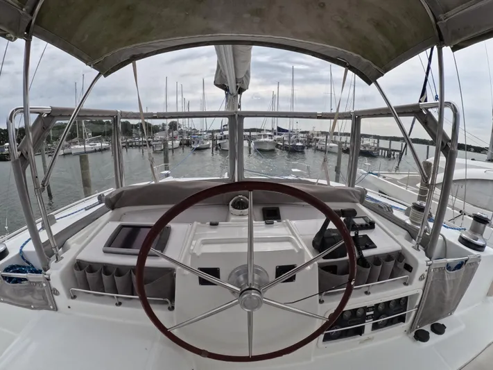 Orion Yacht Photos Pics Helm of 2006 Lagoon 440 catamaran docked at marina, featuring steering wheel and navigation controls.