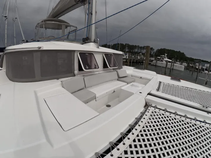 Orion Yacht Photos Pics Lagoon 440 catamaran, 2006 model, docked with spacious deck and netting, under cloudy skies.
