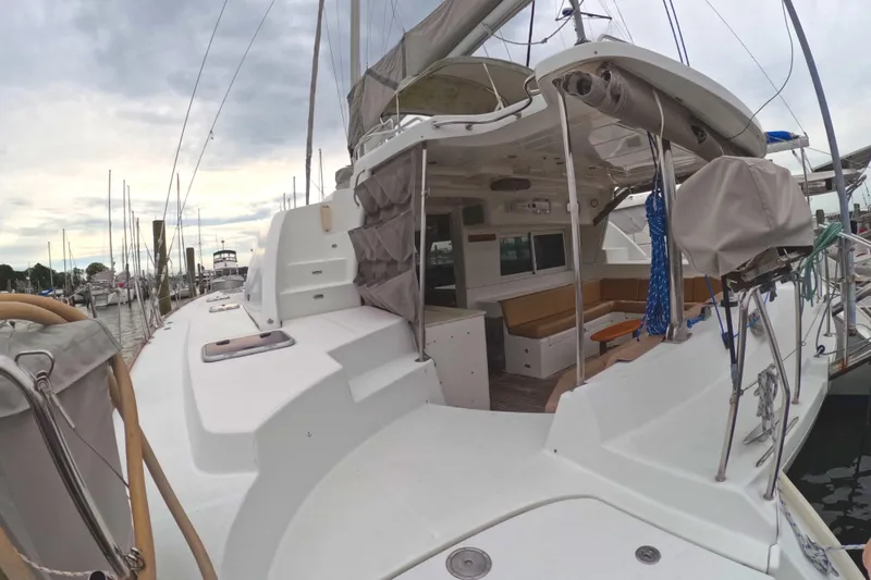 Orion Yacht Photos Pics 2006 Lagoon 440 catamaran docked, showcasing spacious deck and seating area.