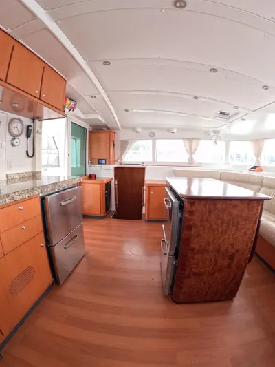 Orion Yacht Photos Pics Spacious interior of 2006 Lagoon 440 catamaran with modern kitchen and seating area.