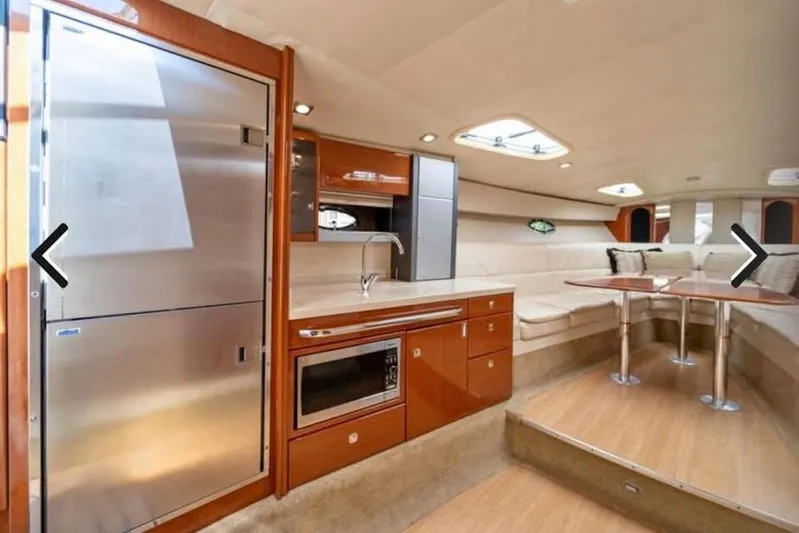  Yacht Photos Pics Luxurious interior of 2011 Formula 400 Super Sport yacht with kitchen and seating area.