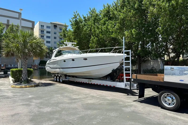  Yacht Photos Pics 2011 Formula 400 Super Sport boat on trailer, parked near buildings and trees.