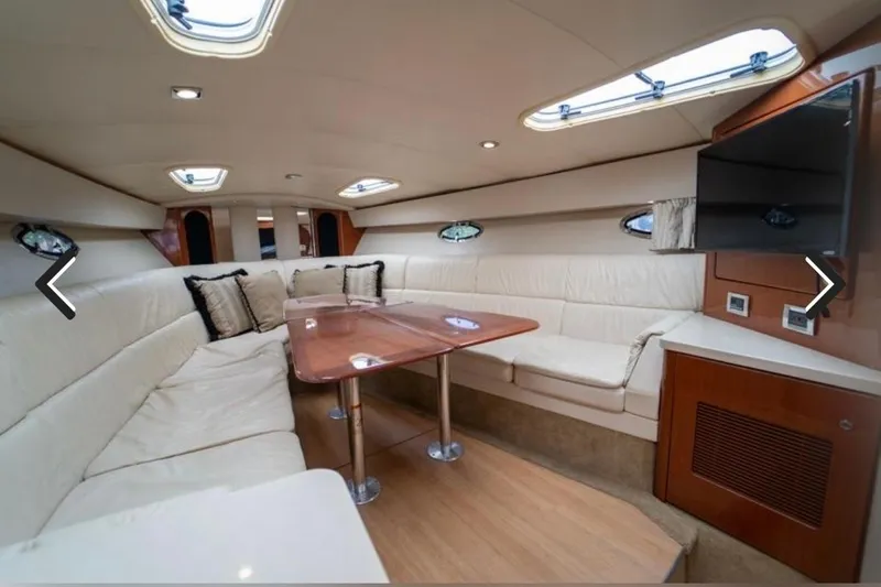  Yacht Photos Pics Interior of 2011 Formula 400 Super Sport yacht with plush seating and wooden table.