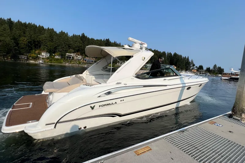  Yacht Photos Pics 2011 Formula 400 Super Sport boat docked on a serene lake with forested background.