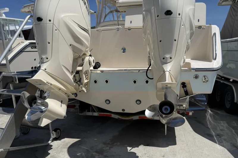 335-714 Used Yacht Photos Pics 2021 Grady-White Freedom 335 boat with dual outboard motors, docked on a trailer.