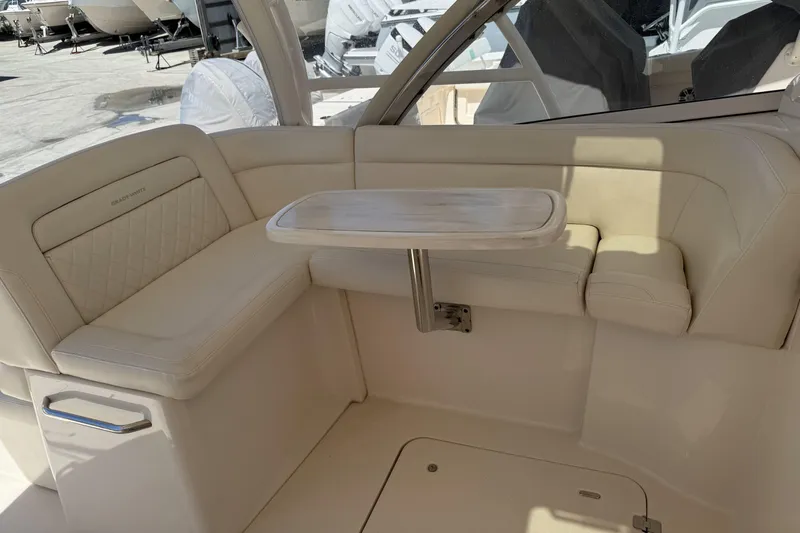 335-714 Used Yacht Photos Pics 2021 Grady-White Freedom 335 boat interior with beige seating and a small table.