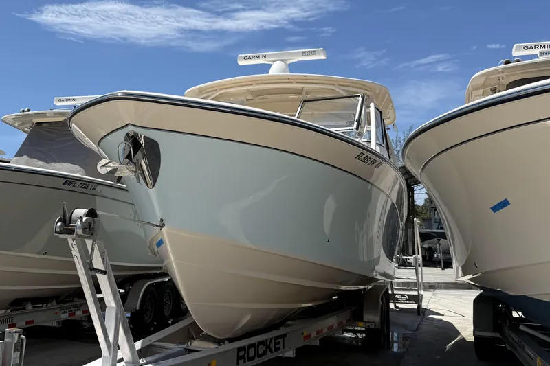 335-714 Used Yacht Photos Pics 2021 Grady-White Freedom 335 boat on trailer under clear blue sky.